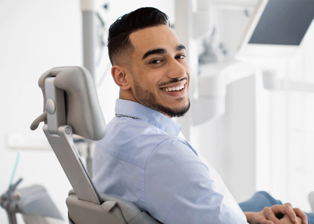 Dentist consulting with a happy patient