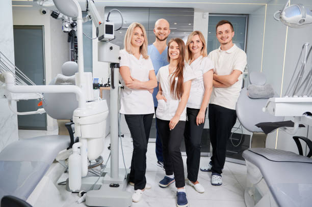 Professional dental team smiling in a modern clinic